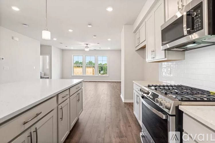 A kitchen with a stove top oven and a microwave.