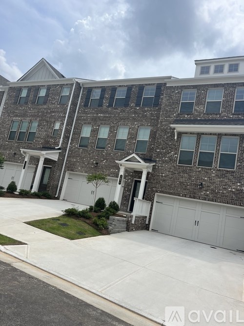A modern two-story house with a garage and a driveway.