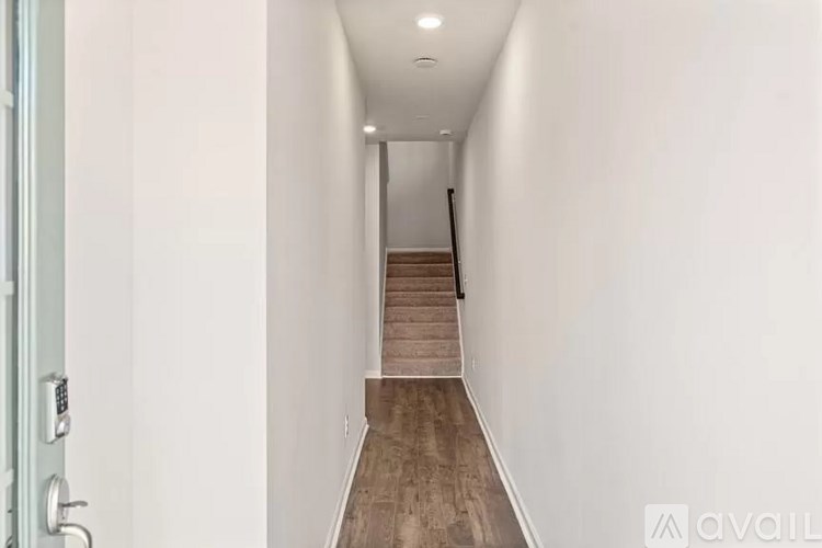 A hallway with a staircase leading to the second floor.