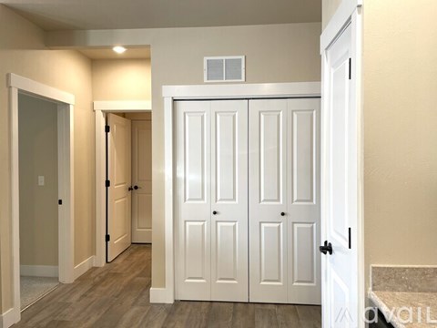 A white double door closet with a small vent on top.