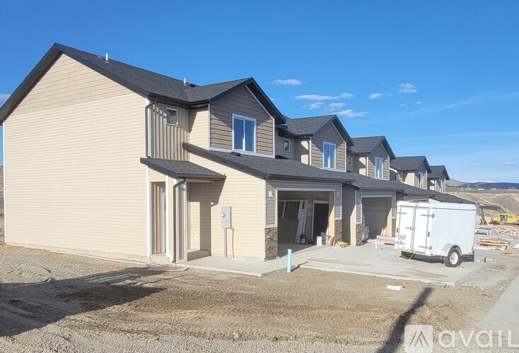 A row of houses with a white van parked in front of them.