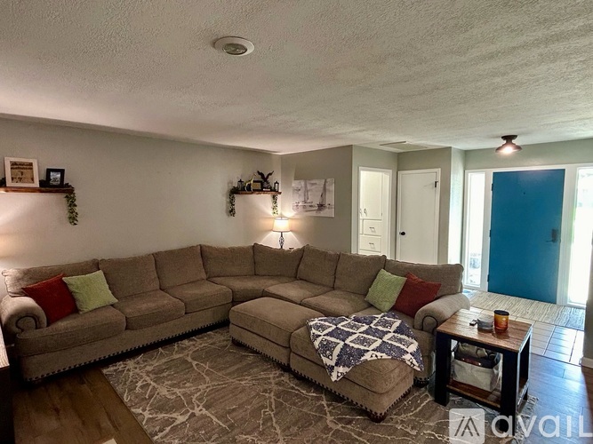 A living room with a large sectional sofa and a coffee table.