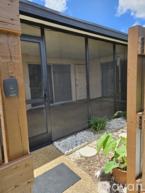A glass door with a handle and a lock is seen from the outside.