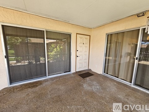 A room with a brown carpet and a door.