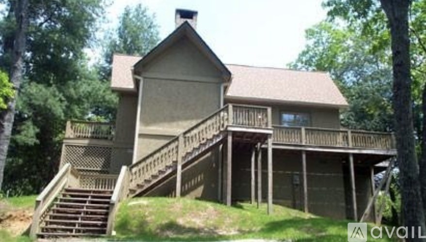 A house with a balcony and stairs leading to the second floor.