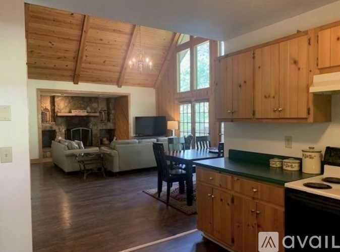 A kitchen with wooden cabinets and a black stove top oven.
