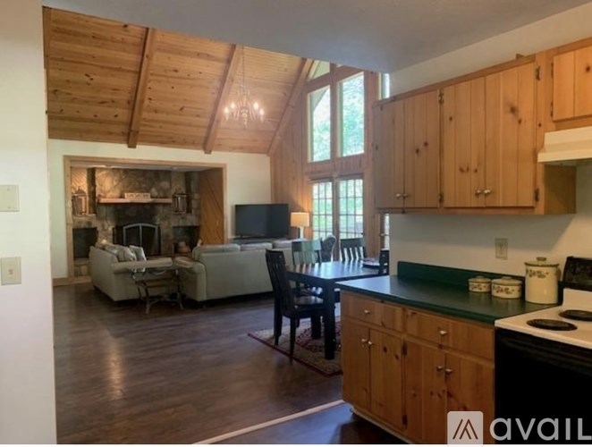 A kitchen with wooden cabinets and a black countertop.