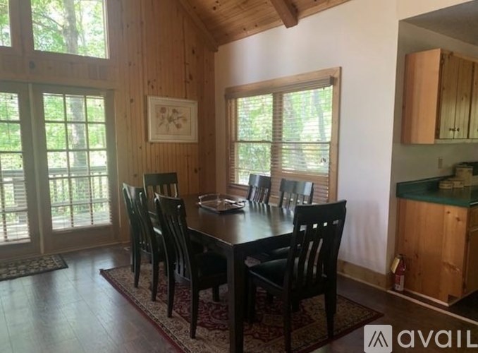 A dining room with a table and chairs.