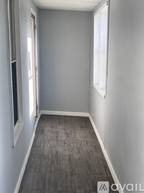 A room with grey walls and wooden flooring.