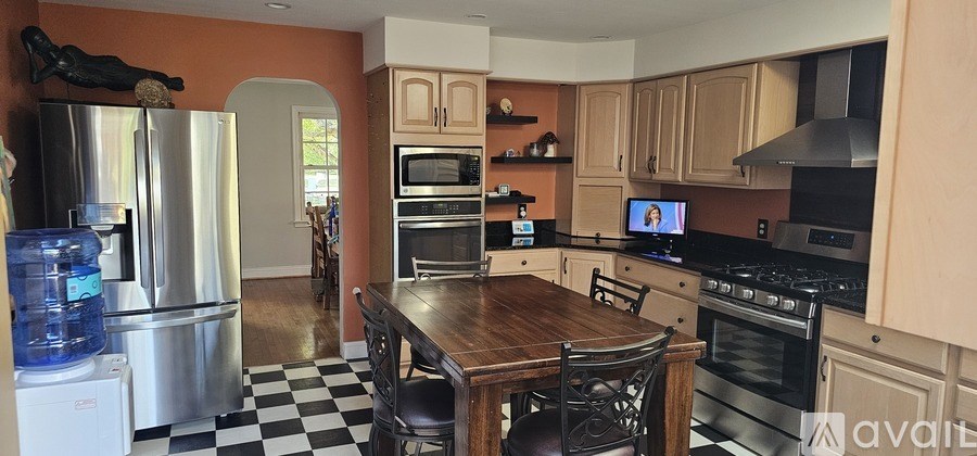A kitchen with a black and white checkered floor.