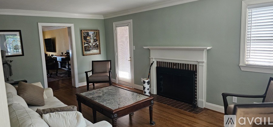 A living room with a fireplace and a table.