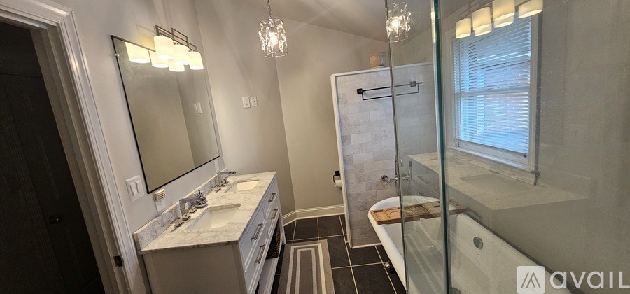 A bathroom with a marble countertop and a walk-in shower.