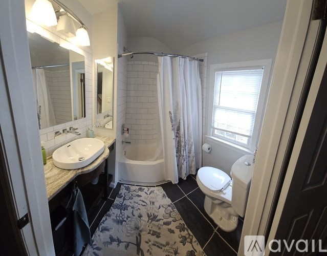 A bathroom with a sink, toilet, and bathtub.