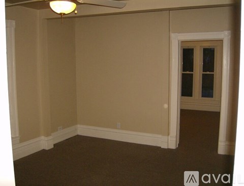 A room with beige walls and a carpeted floor.