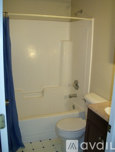 A bathroom with a toilet, sink, and bathtub.