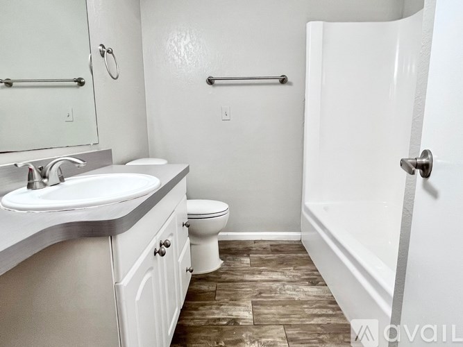 A bathroom with a toilet, sink, and bathtub.