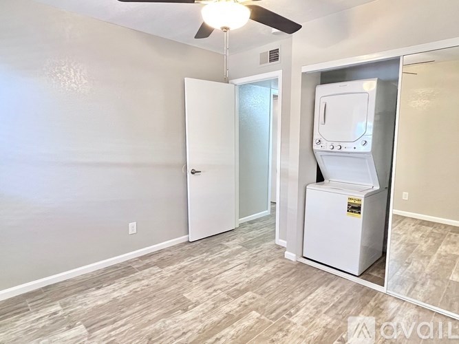 A room with a white door and a white appliance.