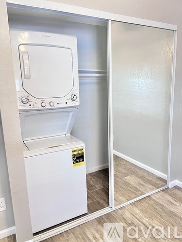A white dishwasher and dryer are installed in a kitchen.