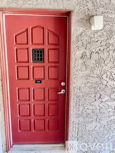 A red door with a number 105 on it.