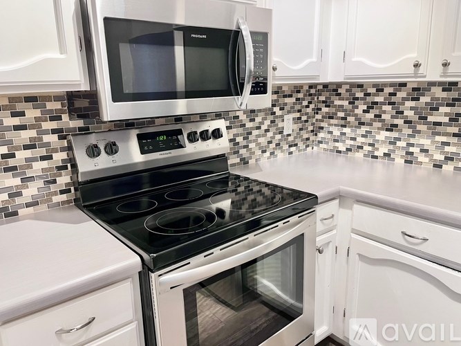 A kitchen with a stove top oven and microwave above it.