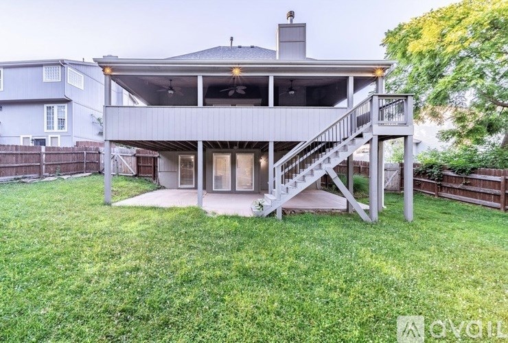 A house with a covered patio and stairs leading to the roof.