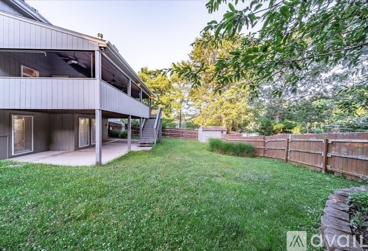 A house with a backyard and a fence.