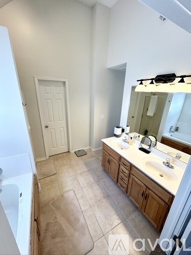 A bathroom with a white tub and sink.