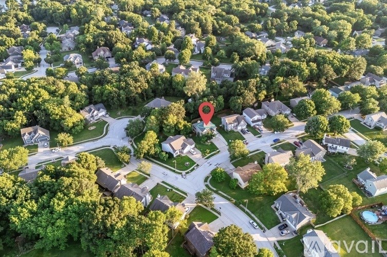 A bird's eye view of a neighborhood with a red pin marking a specific location.