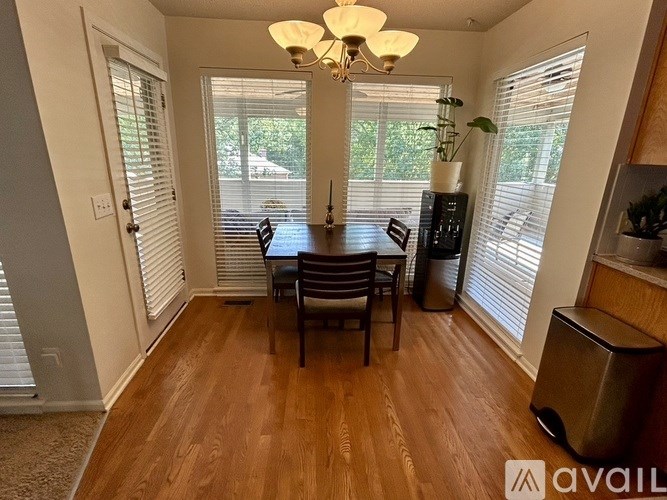 A dining room with a wooden table and chairs.