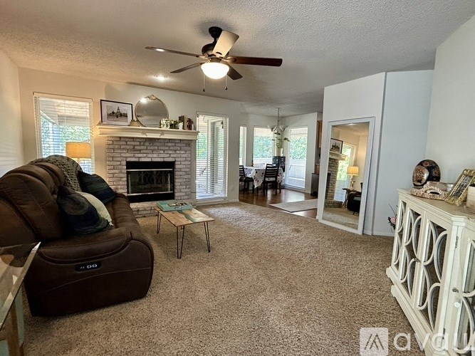 A living room with a fireplace and a brown recliner.