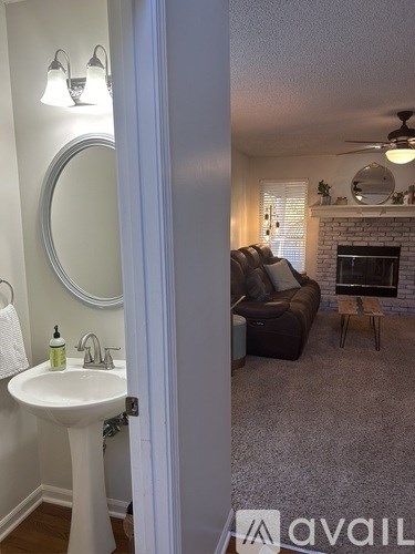 A bathroom with a sink and mirror is shown.