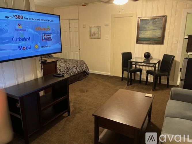 A living room with a television displaying a $300 gas or grocery rewards card.