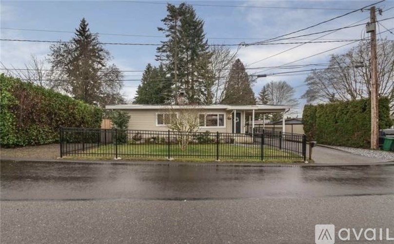 A house with a black fence in front of it.