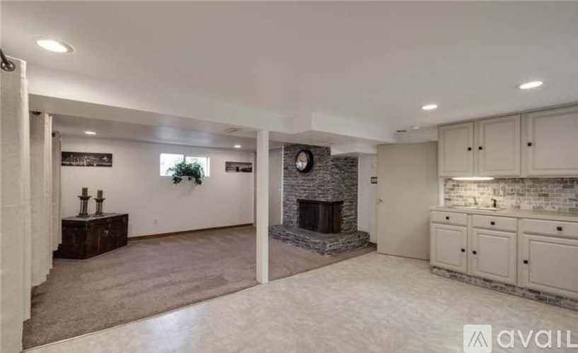 A spacious living room with a fireplace and built-in cabinets.