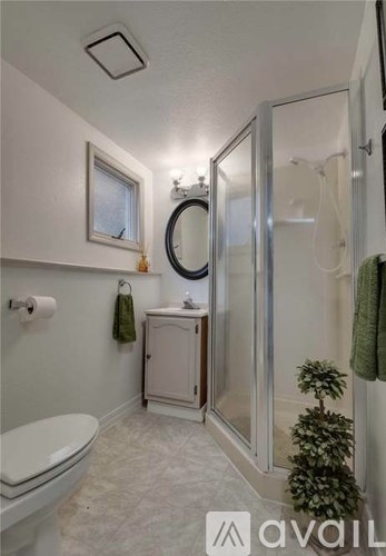 A bathroom with a toilet, sink, and shower.