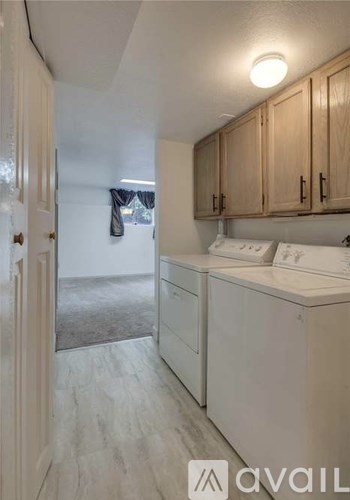 A small laundry room with a washer and dryer.