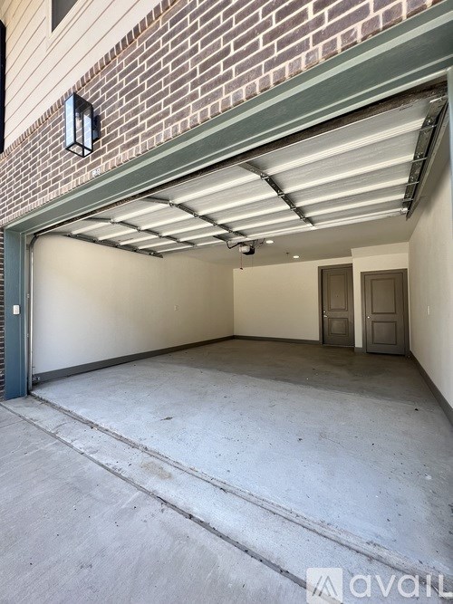 A garage with a brick wall and a metal roof.