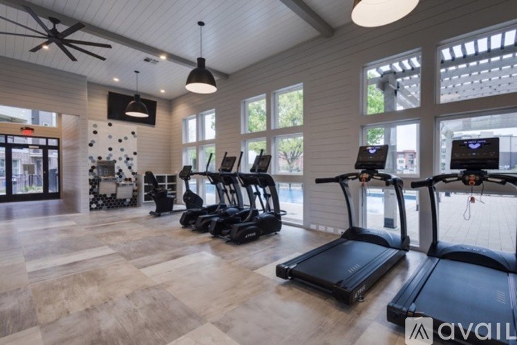 A gym with treadmills and a ceiling fan.