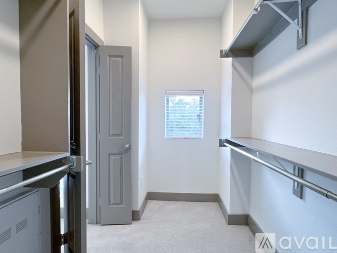 A small, empty room with a window and a door.