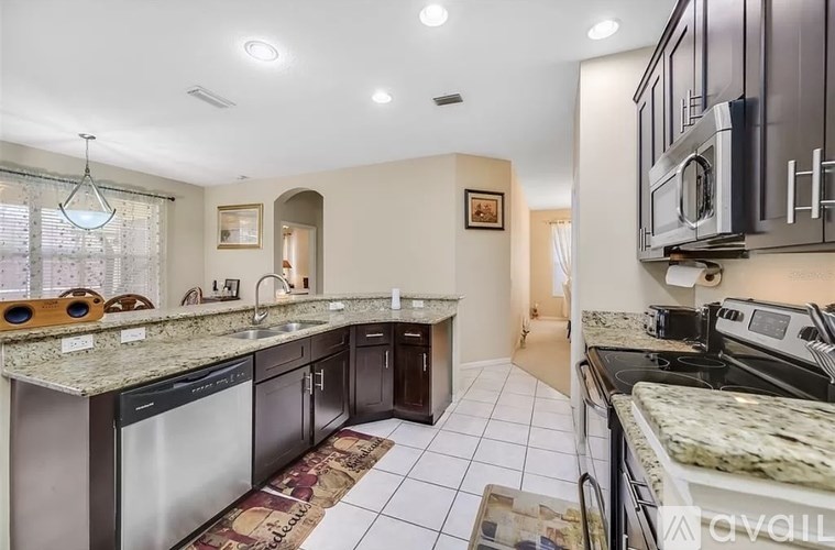 A kitchen with granite countertops and stainless steel appliances.