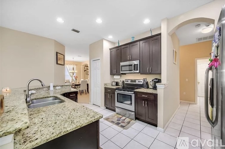A kitchen with granite countertops and stainless steel appliances.