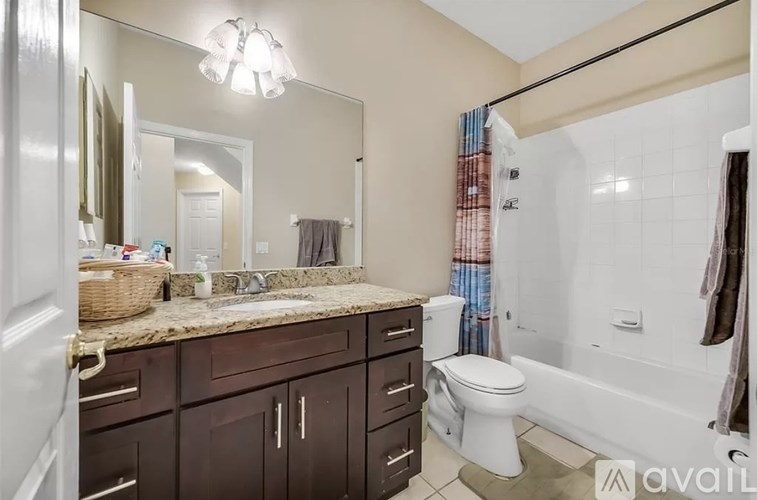 A bathroom with a white toilet, sink, and bathtub.