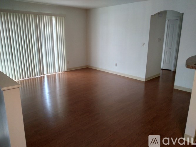 A room with wooden floors and white walls.