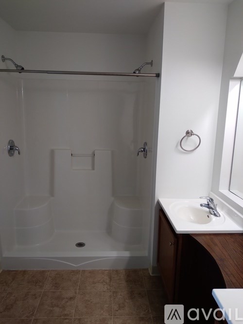 A bathroom with a white tub and sink.