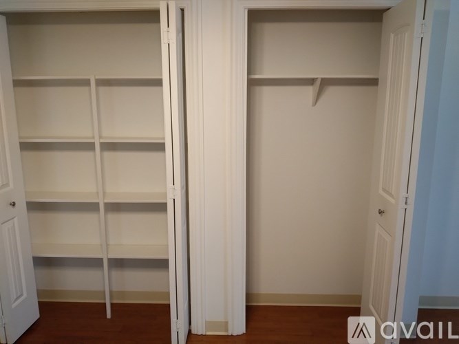 A white closet with shelves and a door.