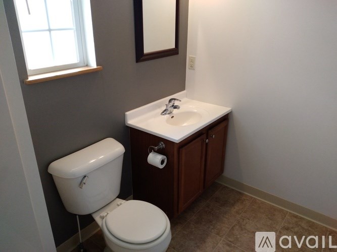 A white toilet sits next to a sink in a bathroom.