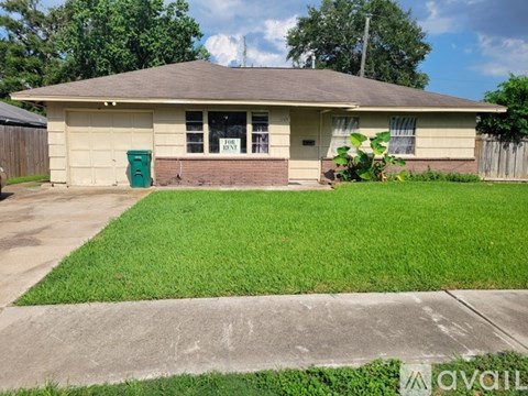 A house with a green lawn and a brown roof.