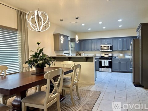 A modern kitchen with a dining table and chairs.