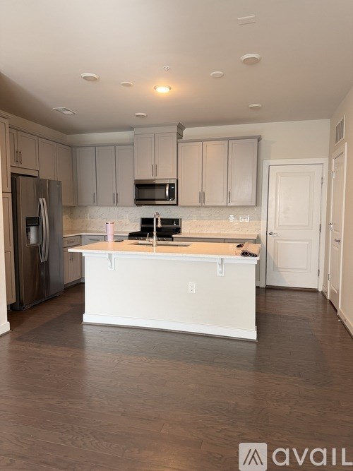 A kitchen with a white island in the middle.