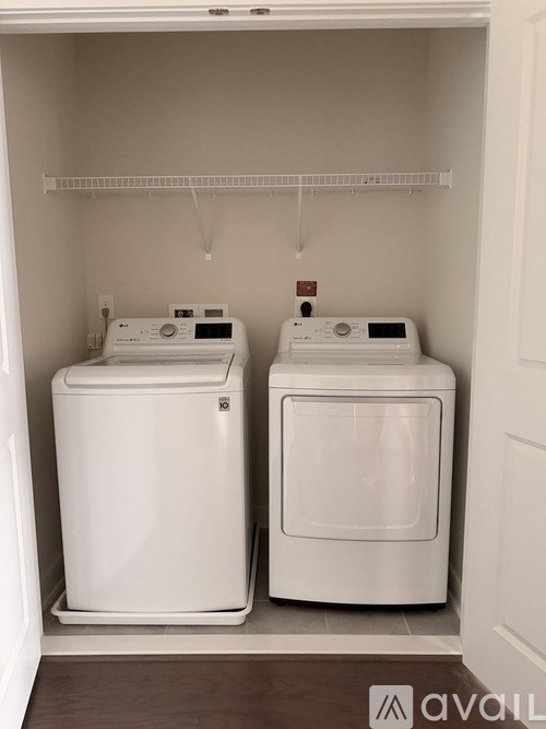 A small laundry room with a washer and dryer.